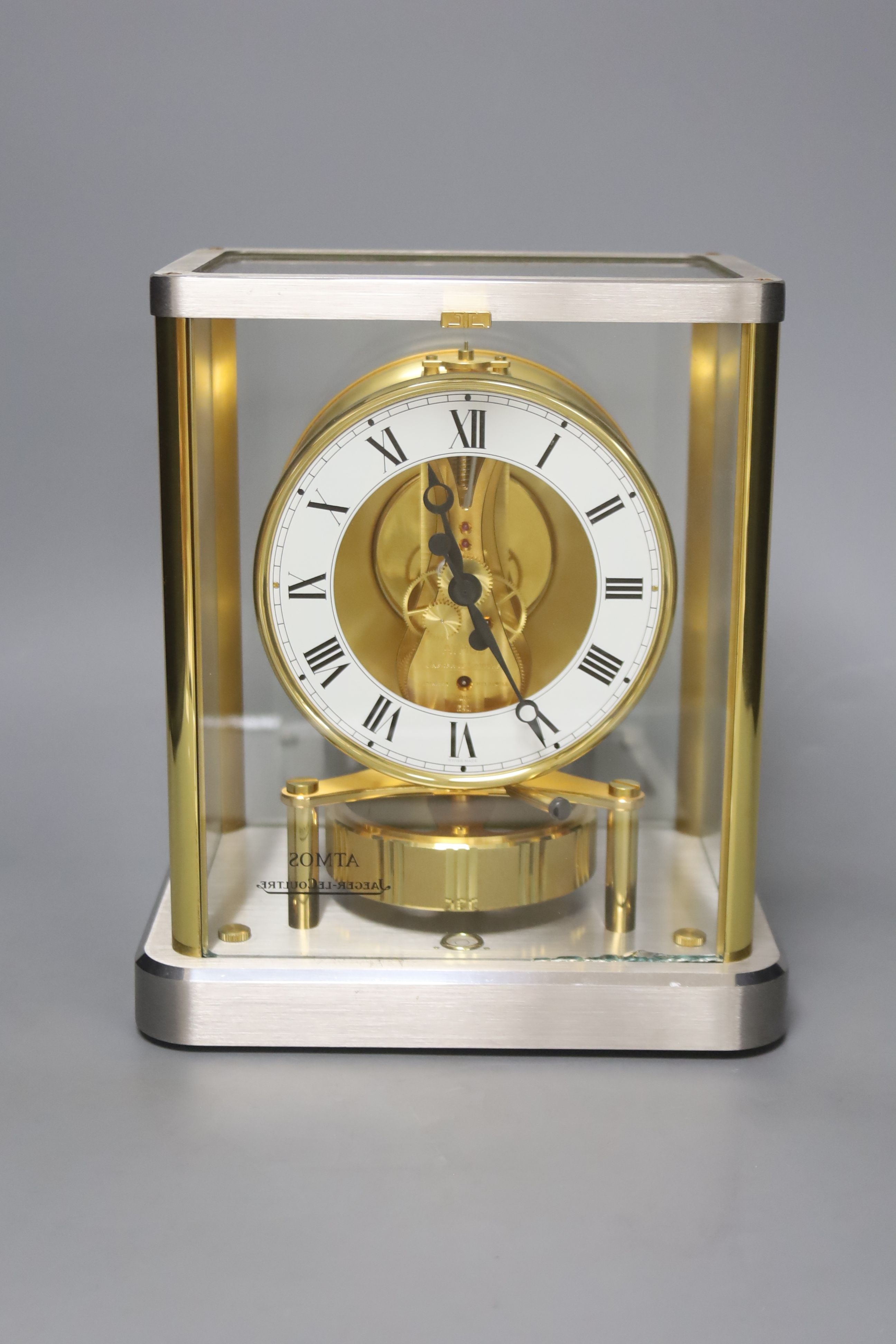 A Jaeger le Coultre Atmos mantel clock, in silvered and gilt metal glazed panelled case, height 23cm
